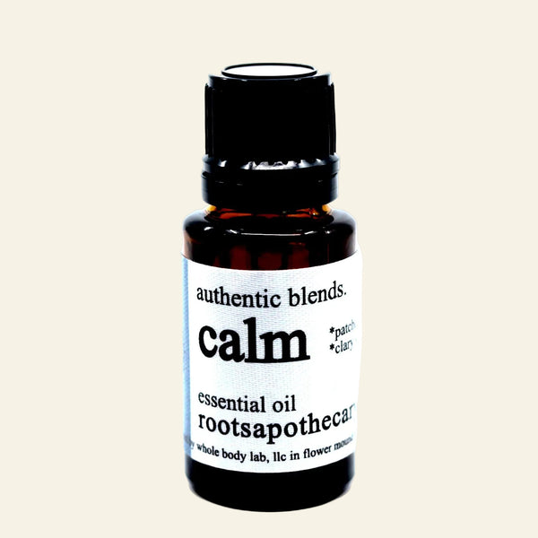 Essential oil bottle labeled 'calm' by Rootsapotheque on a white background