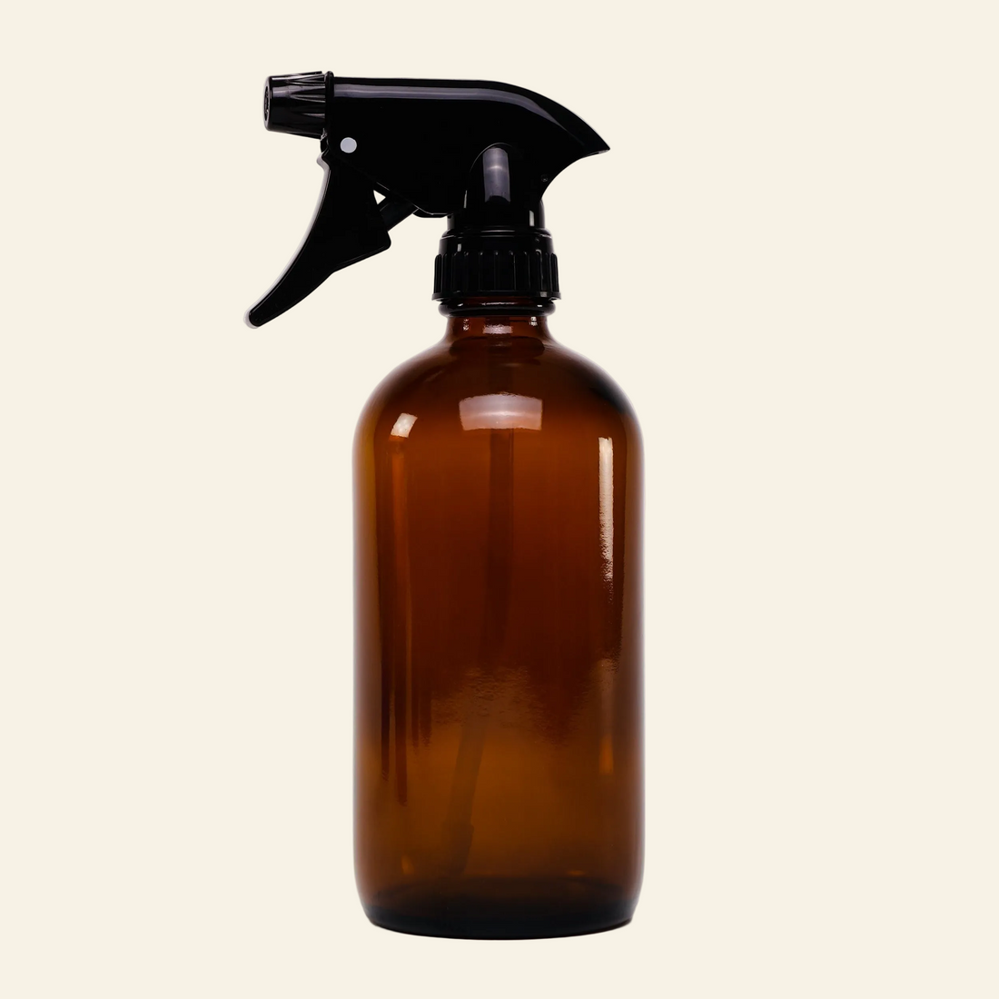 Brown spray bottle with black nozzle on a light gray background