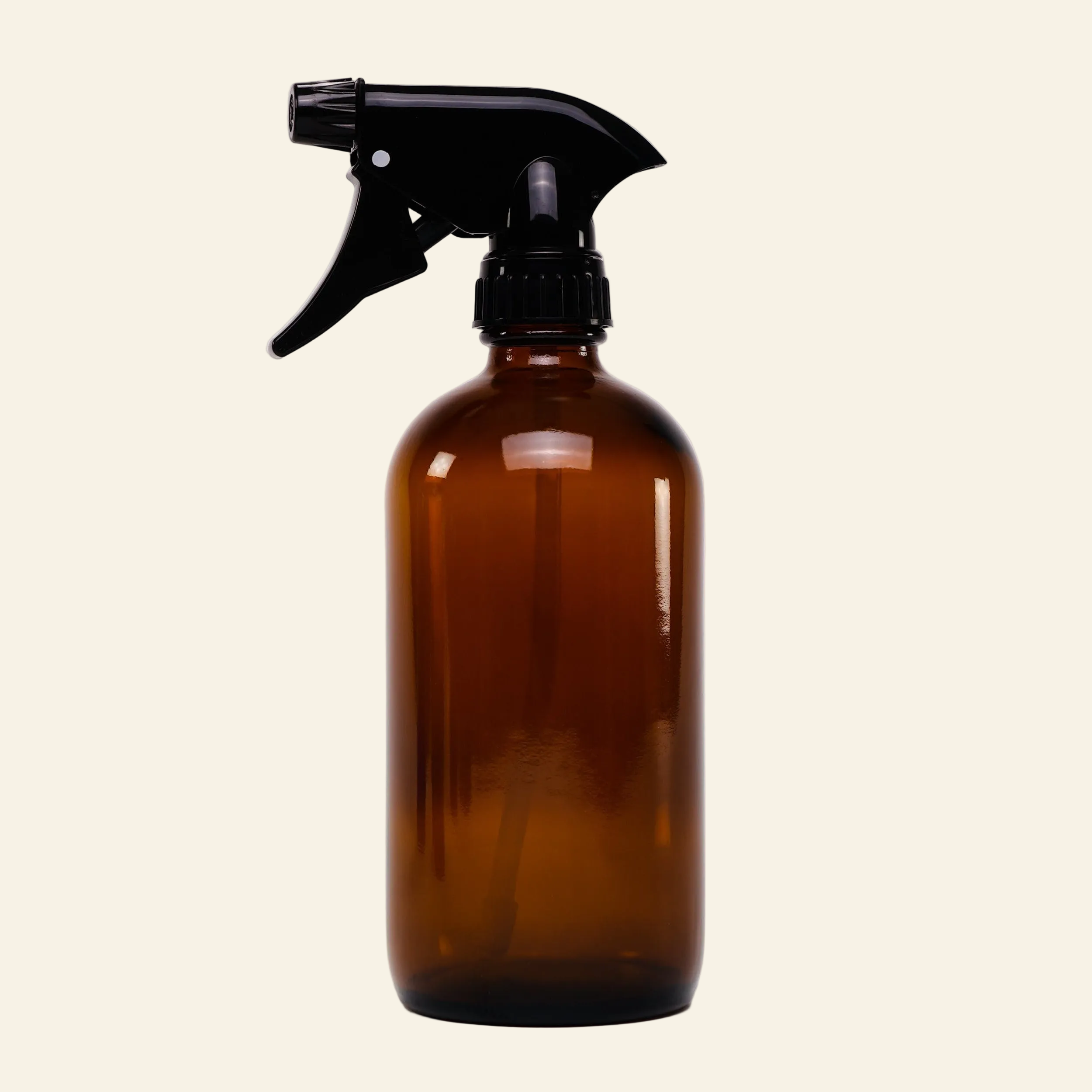 Brown spray bottle with black nozzle on a light gray background