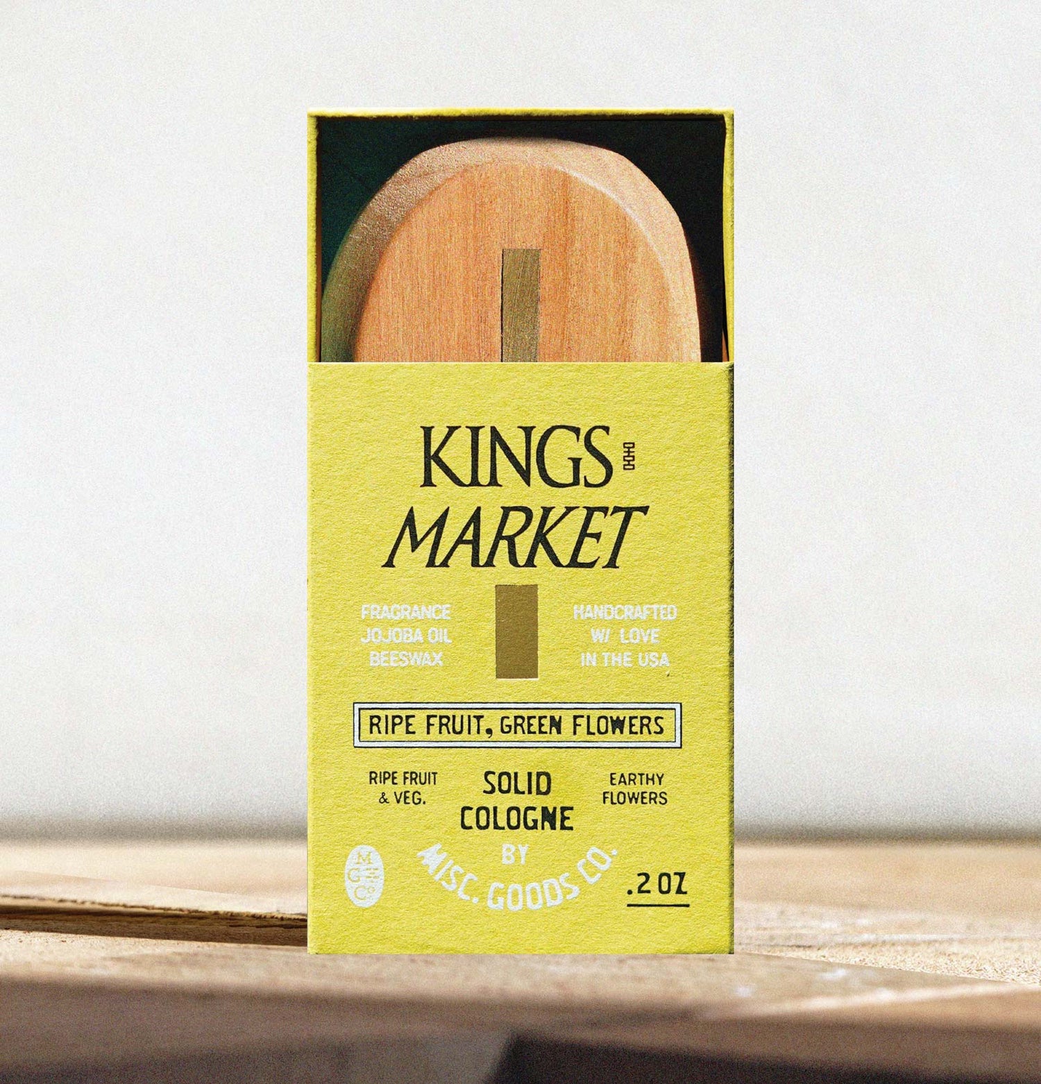 Kings Market solid cologne packaging with wooden applicator on a white background