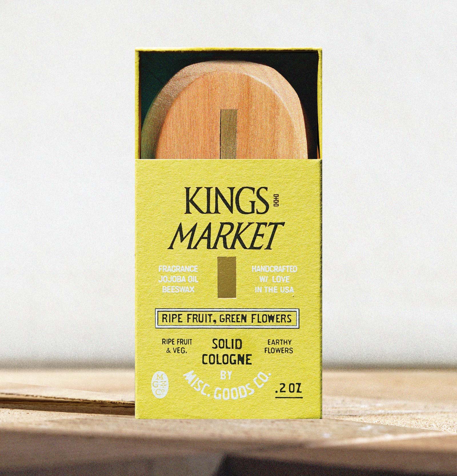 Kings Market solid cologne packaging with wooden applicator on a white background