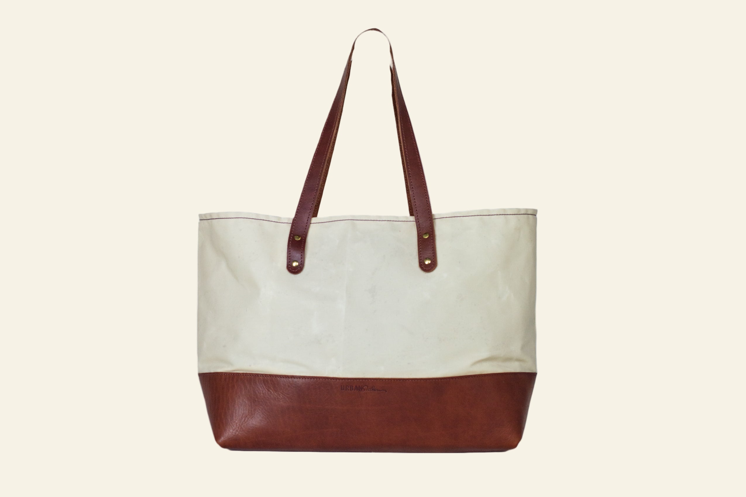 Tote bag with brown bottom half and beige top half on a white background