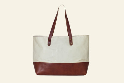 Tote bag with brown bottom half and beige top half on a white background