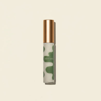 Skincare serum bottle with camouflage design and wooden cap on a beige background
