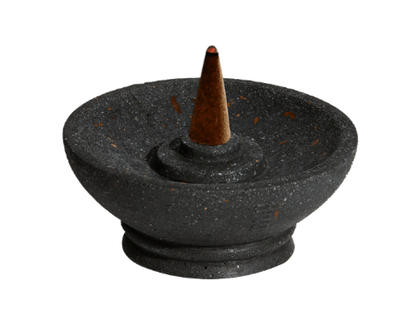 Black stone incense burner with a single incense cone on a white background