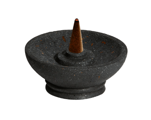 Black stone incense burner with a single incense cone on a white background
