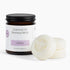 A jar of Fontana Candle Co. Essential Oil Beeswax Melts in the lavender scent, shown next to two round off-white wax melts on a clean white background.