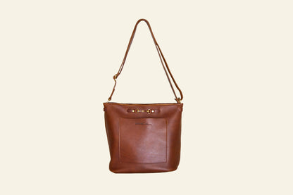 Brown leather handbag with a strap on a white background