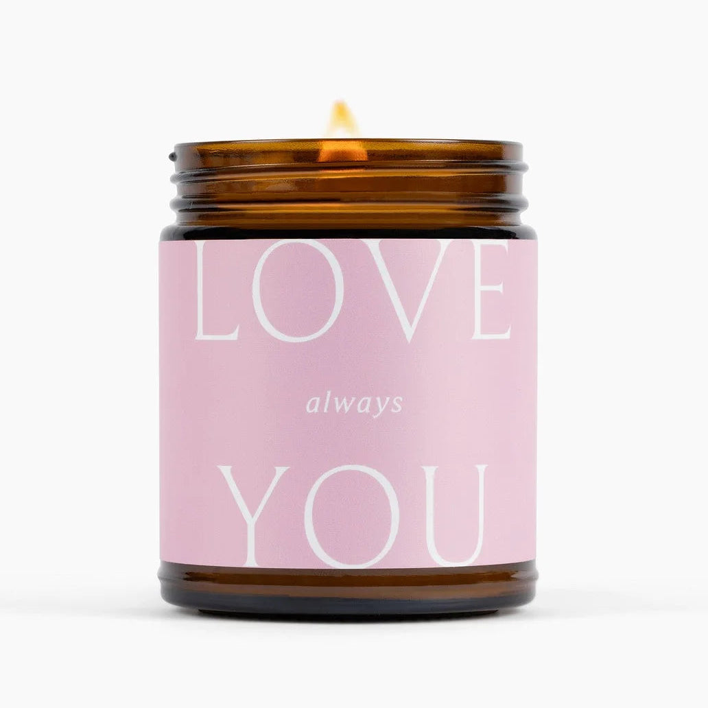 Candle with a pink label reading &