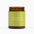 Candle with a green label and brown lid on a white background