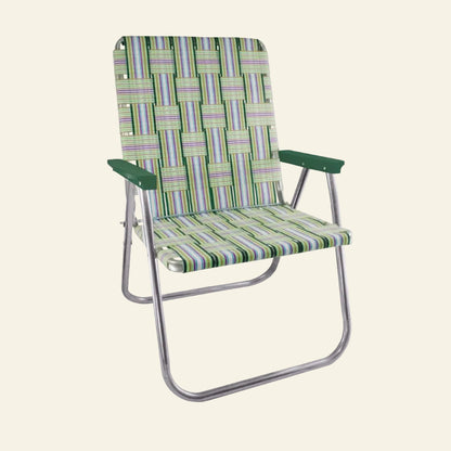 A folding outdoor lounge chair with a woven green, blue, and purple striped fabric seat and backrest, supported by a curved silver metal frame with dark green armrests.
