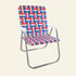 A folding beach chair with a woven red, white, and blue patterned sling seat and backrest, supported by a curved silver metal frame, shown on a plain white background.