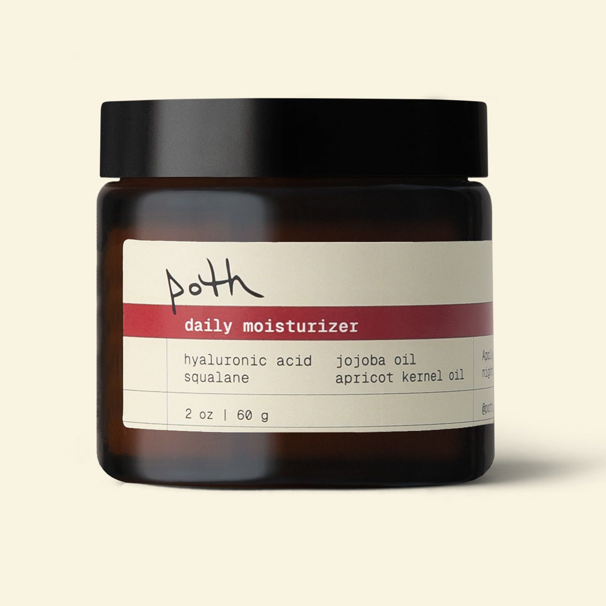 A jar of Poth Daily Moisturizer with a black lid, amber glass jar, and a cream-colored label with a red stripe, set against a solid light beige background.