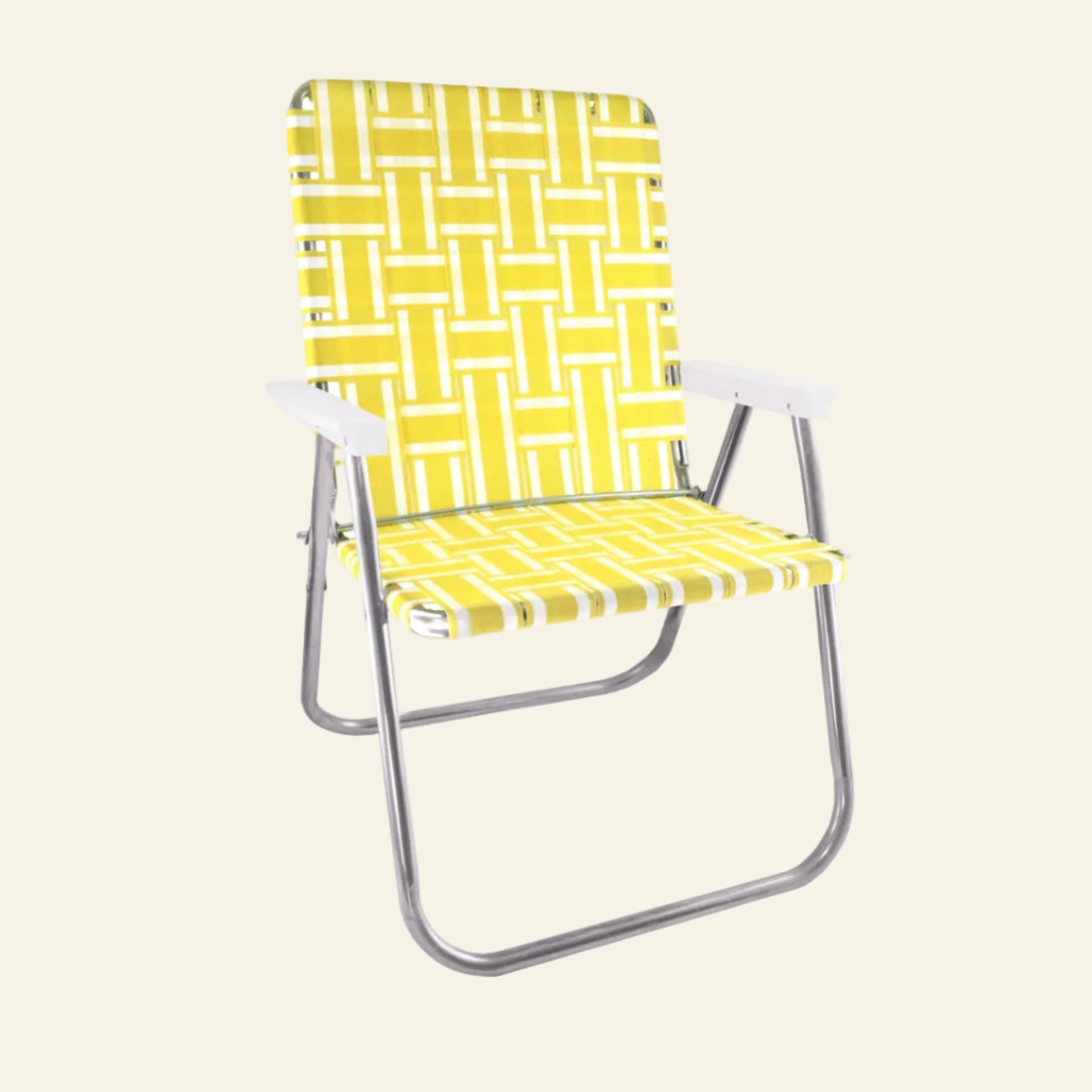 A folding beach chair with a bright yellow and white geometric basketweave patterned sling seat and backrest, supported by a curved silver metal frame.