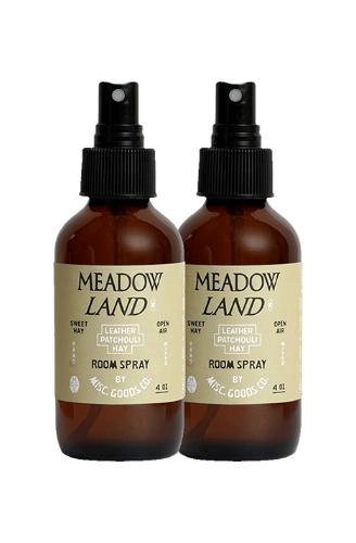 Two bottles of Meadow Land room spray on a white background