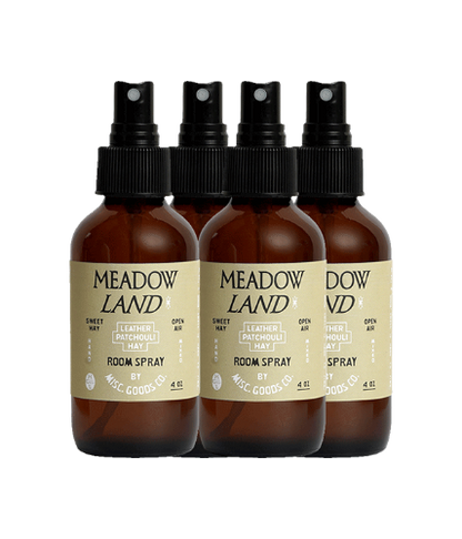 Four bottles of Meadow Land room spray on a white background