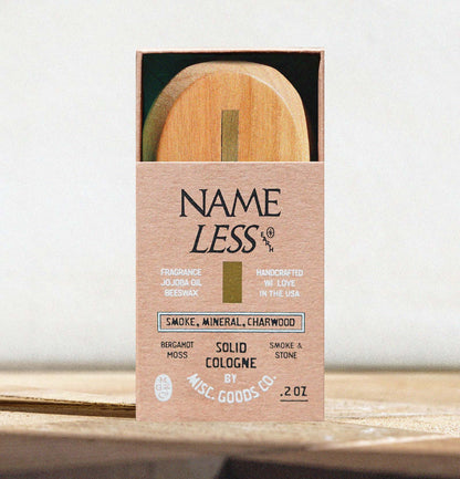 Solid cologne packaging with wooden applicator on a white background
