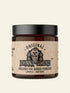 Jar of Johnny Slicks organic oil-based pomade with a skull design on the label.