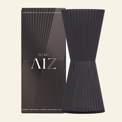 Black ribbed decorative item with packaging featuring &