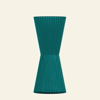 Teal ribbed vase on a light gray background