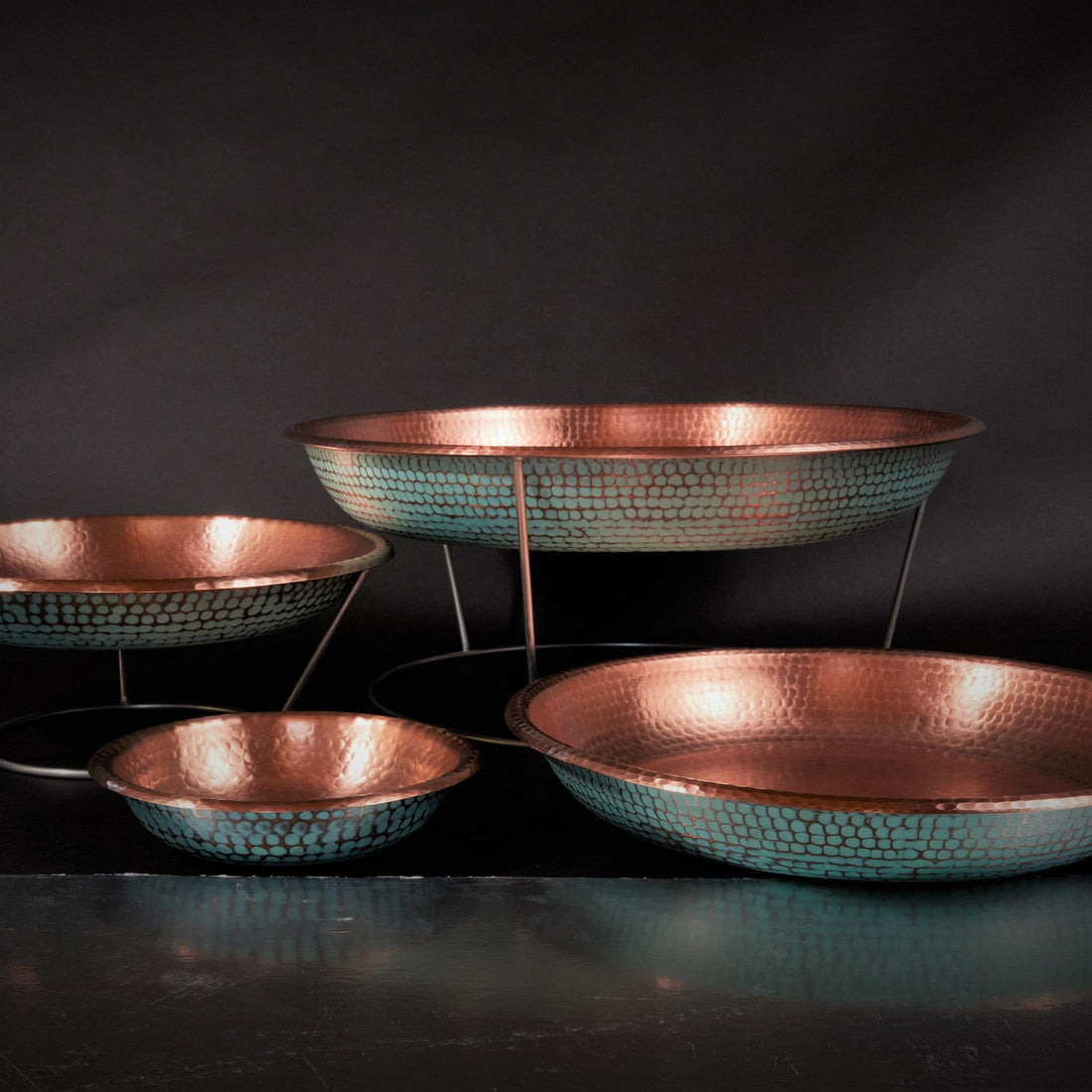 Set of copper bowls on a dark background