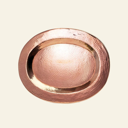 Copper plate with a hammered texture on a light gray background