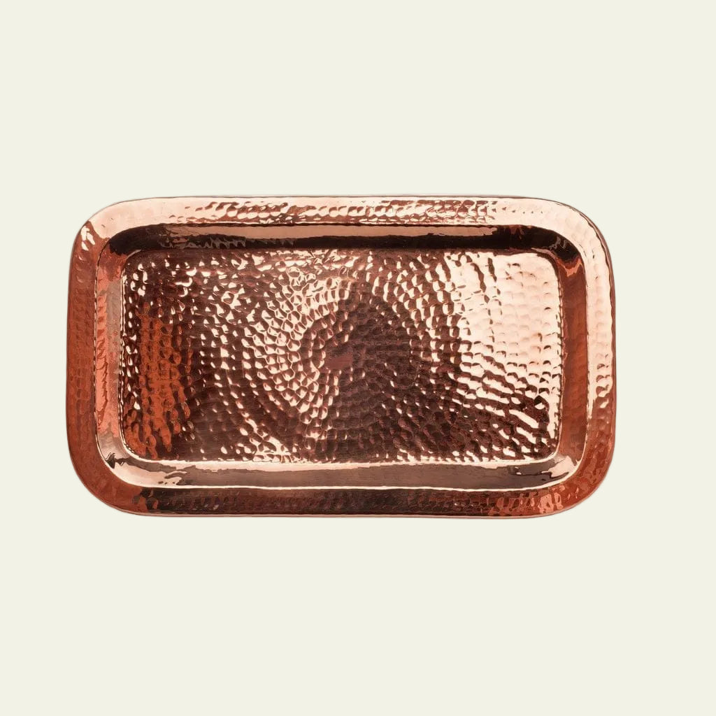 Copper tray with a hammered texture on a white background