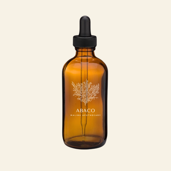 Amber glass dropper bottle with black cap on a white background, featuring the Abaco Malibu Apothecary logo.