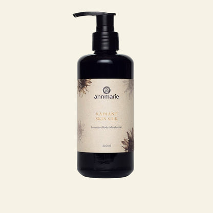 Black bottle of Annmarie Radiant Skin Silk body moisturizer on a white background