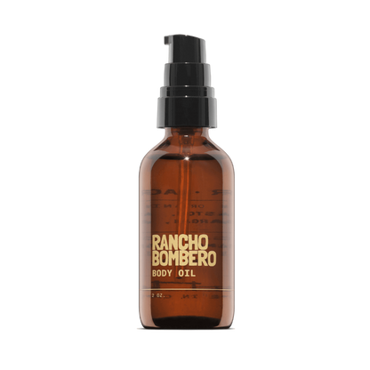 Rancho Bombero body oil bottle on a black background
