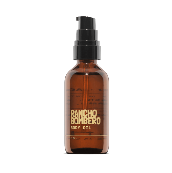 Rancho Bombero body oil bottle on a black background