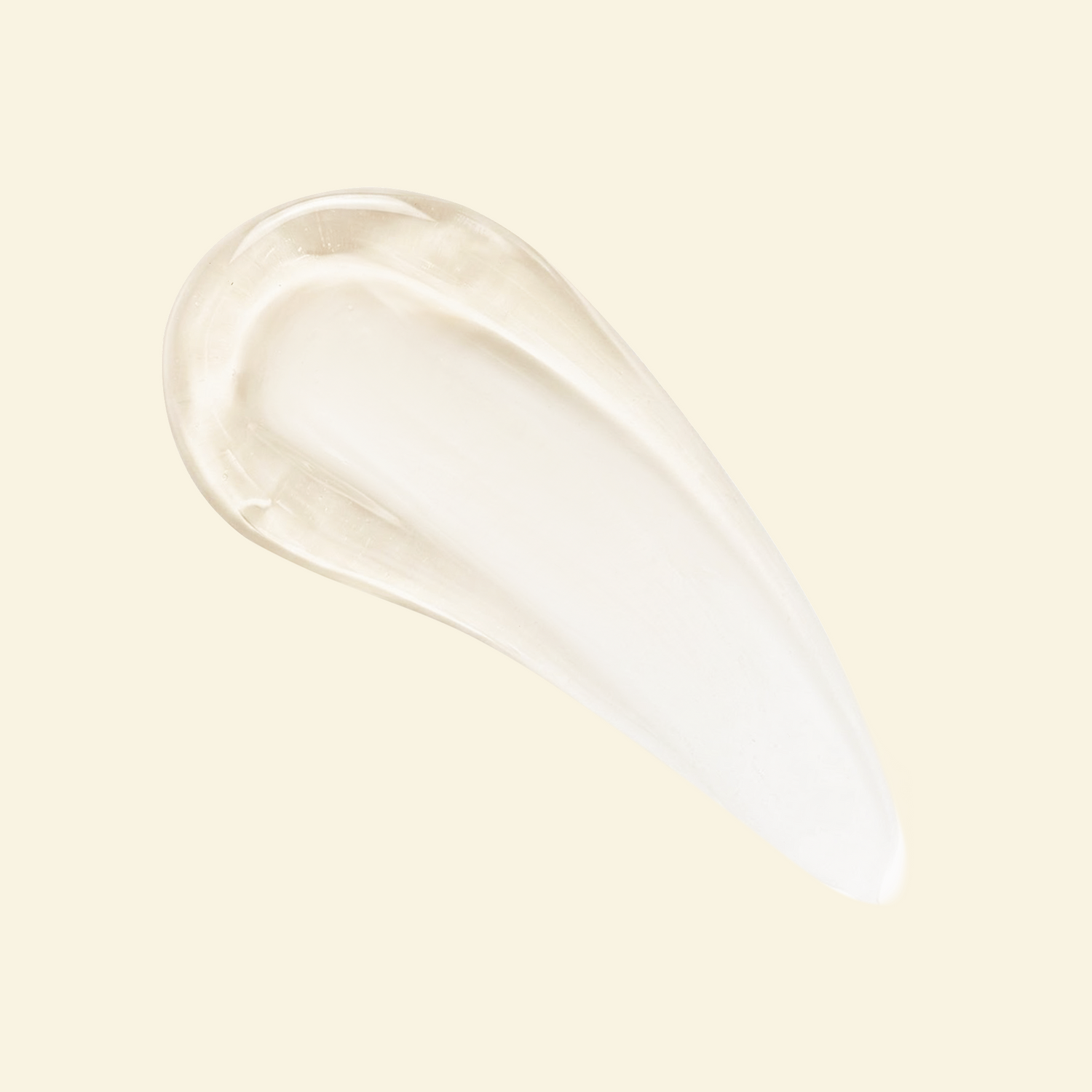 A glossy, translucent smear of a clear cosmetic gel or serum on a solid pale cream background.