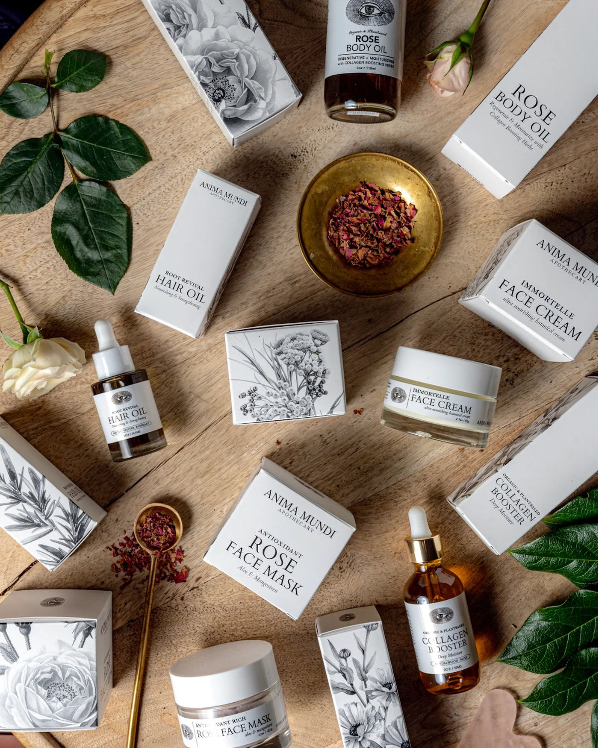 Collection of Anima Mundi skincare products on a wooden surface with green leaves.