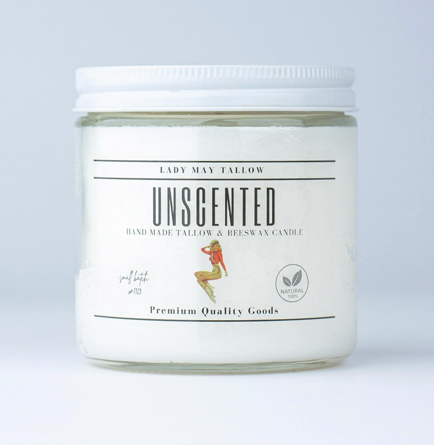 Unscented candle in a glass jar with a white label on a light gray background