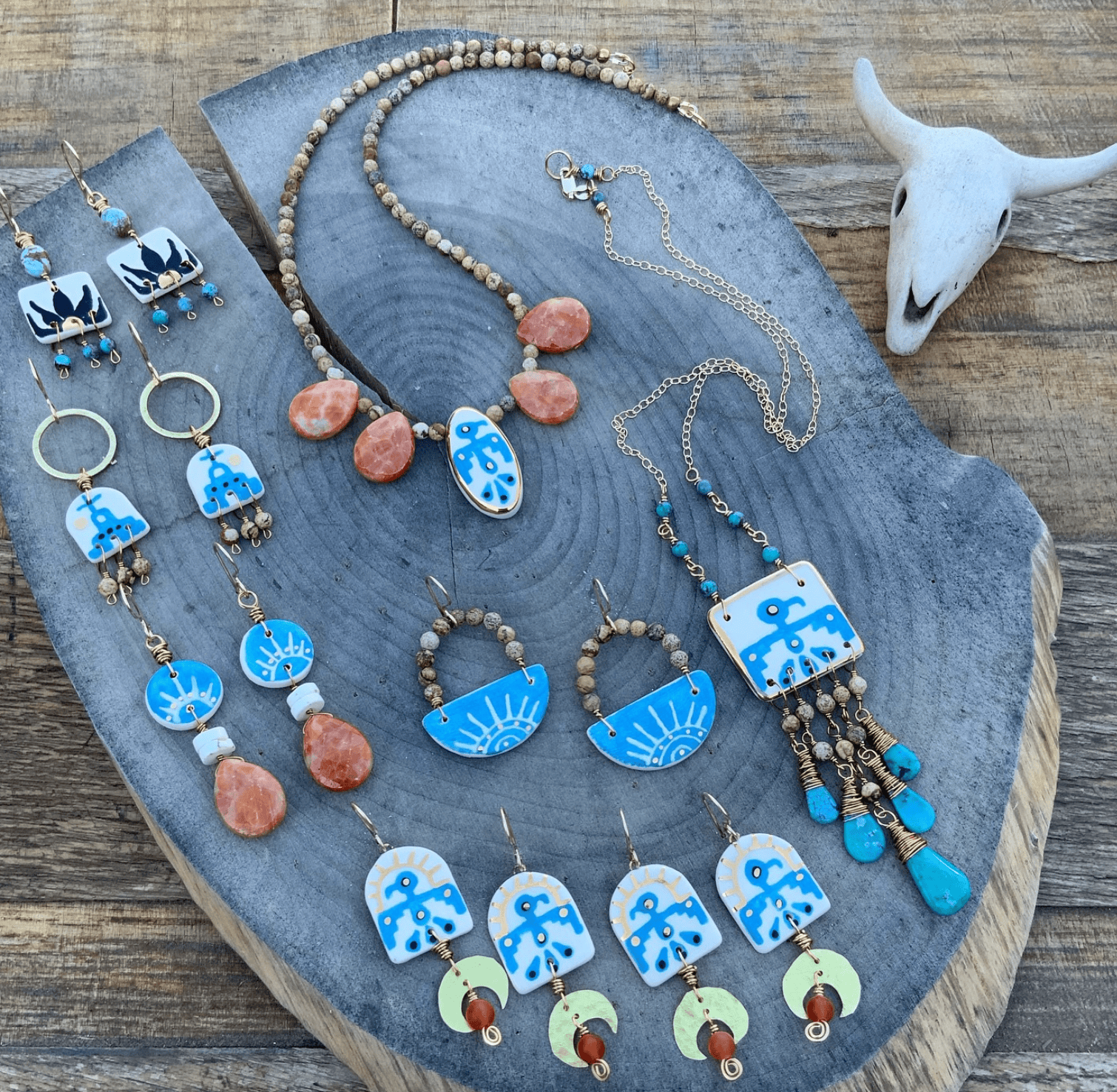 Jewelry set with necklaces and earrings on a wooden surface