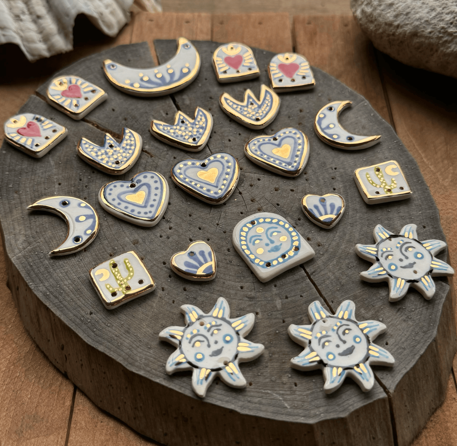 Collection of ceramic charms on a wooden surface