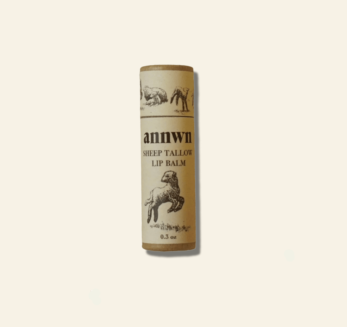 Sheep tallow lip balm tube with branding on a beige background