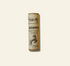 Sheep tallow lip balm tube with branding on a beige background