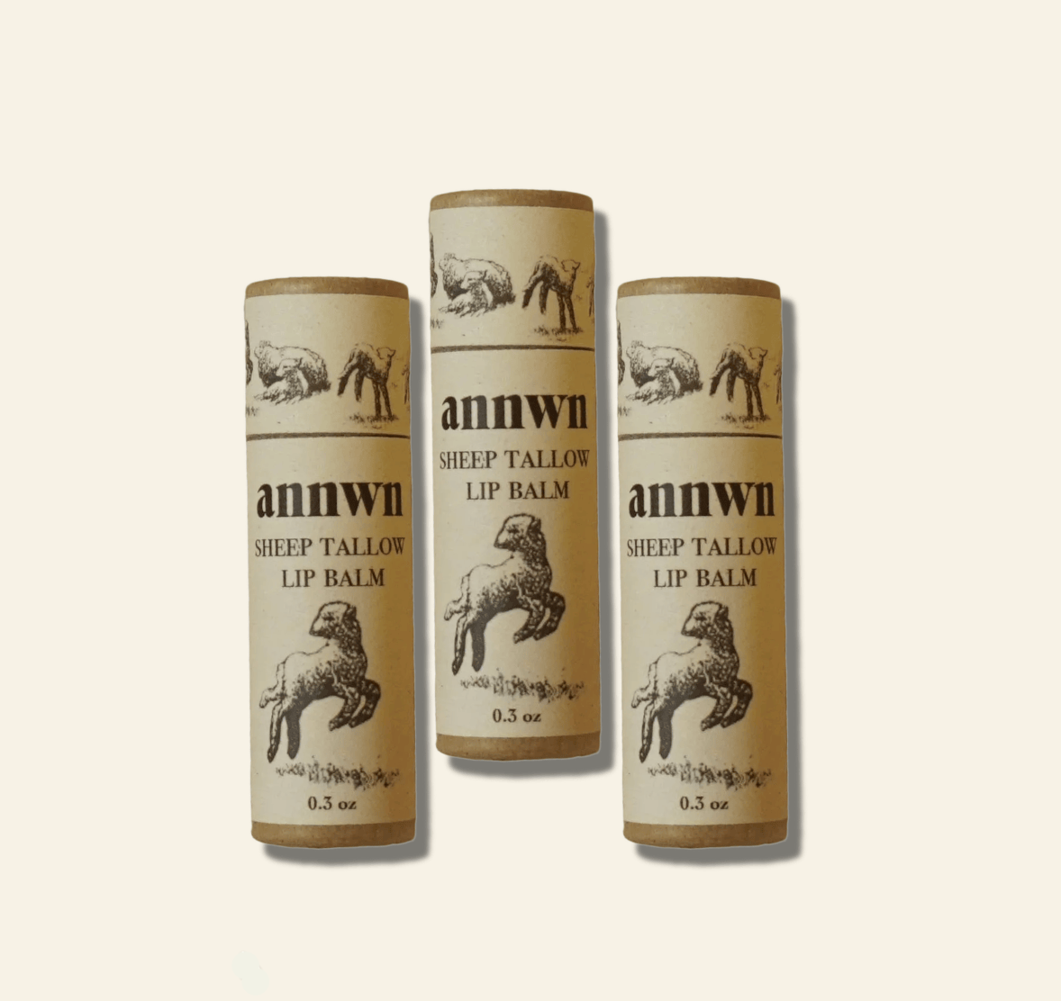 Three tubes of annwn sheep tallow lip balm on a white background