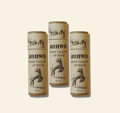 Three tubes of annwn sheep tallow lip balm on a white background