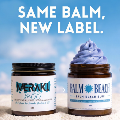 Two amber balm jars on a sandy surface with a blue sky background. The left jar has a black lid and a white label reading MERAKI NaNo, and the right jar has a blue lid and a white label reading Balm Beach Balm Beach Blue, with a swirl of lavender-blue balm displayed above it.