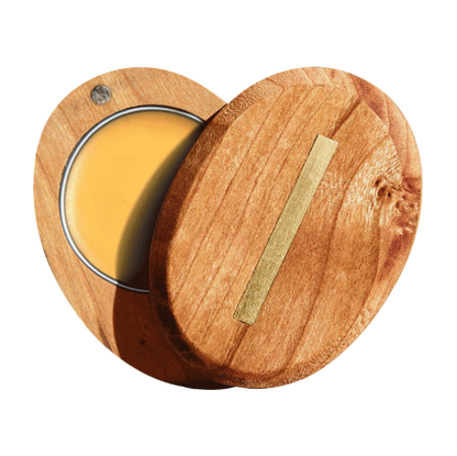 Wooden container with a gold strip and yellow substance inside on a white background