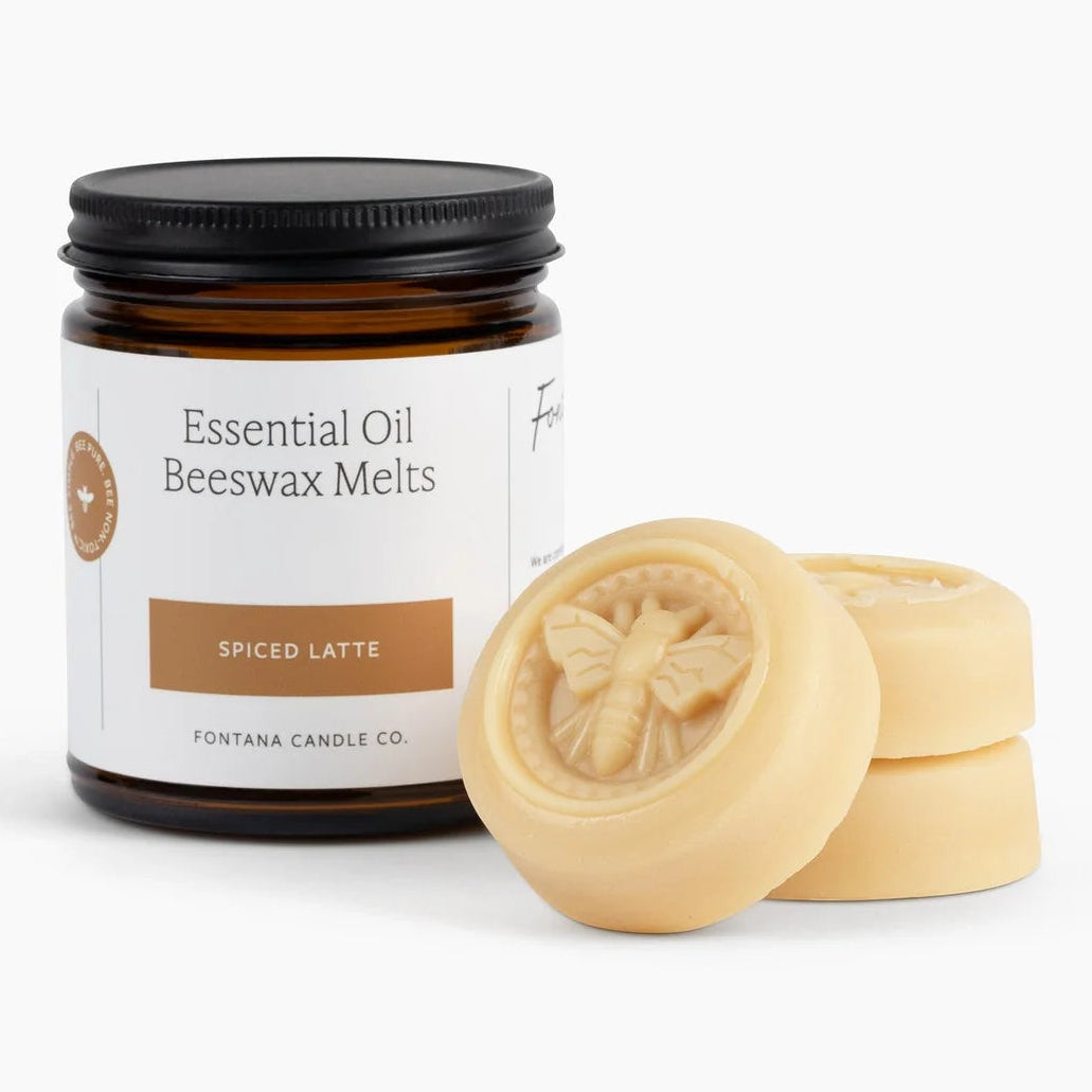 A jar of Fontana Candle Co. Essential Oil Beeswax Melts in the Spiced Latte scent, shown with two pale yellow wax melts in front on a clean white background.