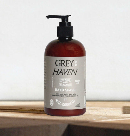 Bottle of Grey Haven hand wash on a wooden surface with a white background