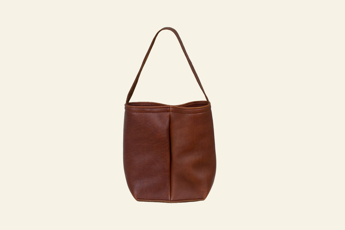 Brown leather handbag on a white background