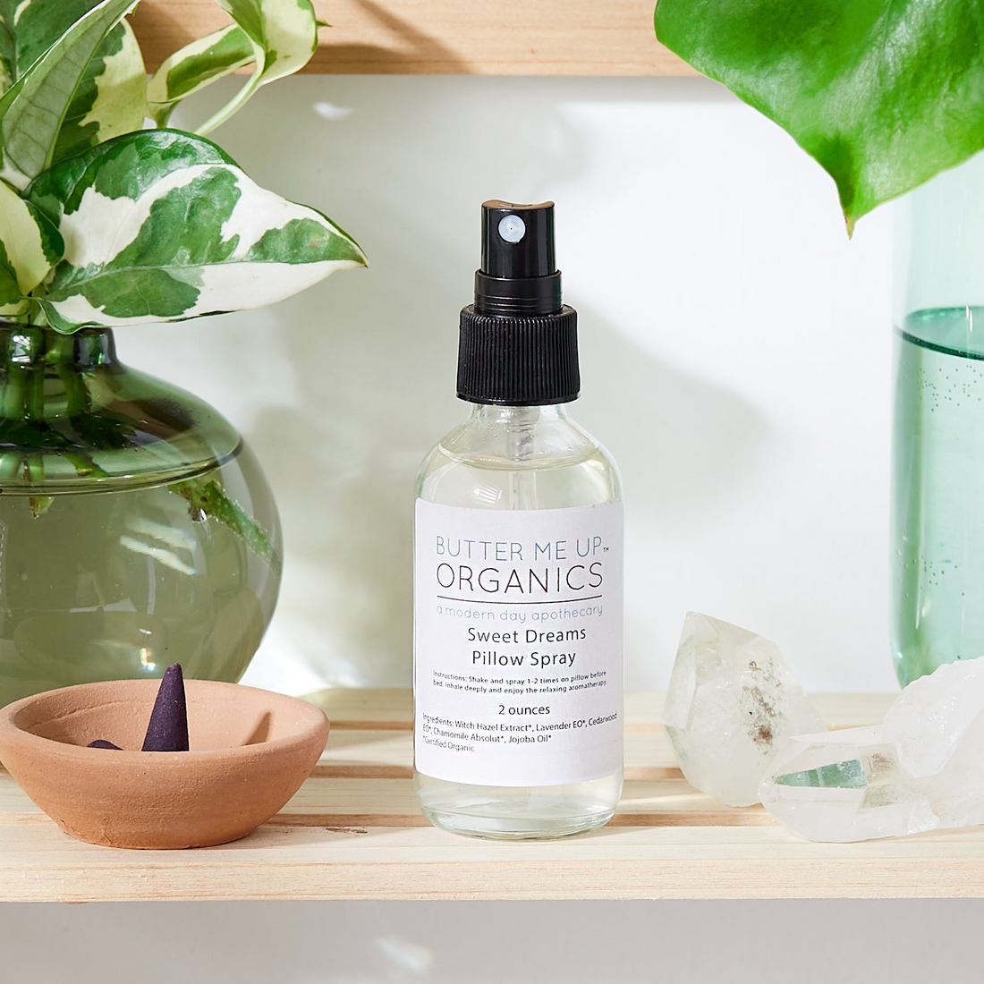 Bottle of organic skincare product on a shelf with plants and decor