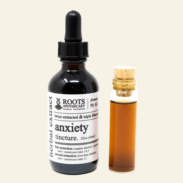 Bottle of Roots Apothecary Anxiety Tincture with dropper and small vial on a white background