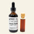 An amber glass dropper bottle labeled Roots Apothecary Lemon Balm tincture next to a small cork vial containing the amber liquid, on a white background.
