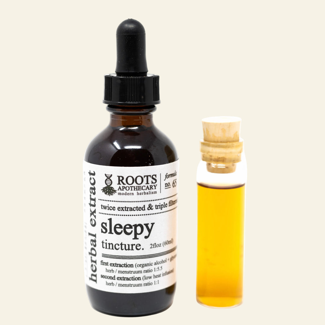 Bottle of Roots Apothecary sleepy tincture with dropper and small vial of liquid on a white background