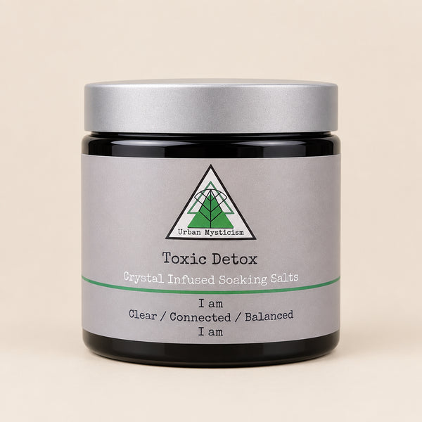 Jar of 'Toxic Detox' crystal infused soaking salts with a label on a natural background